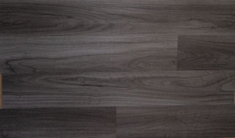 Porcelain tile and vinyl flooring meet in a busy home entryway with boots, mats, and everyday foot traffic.