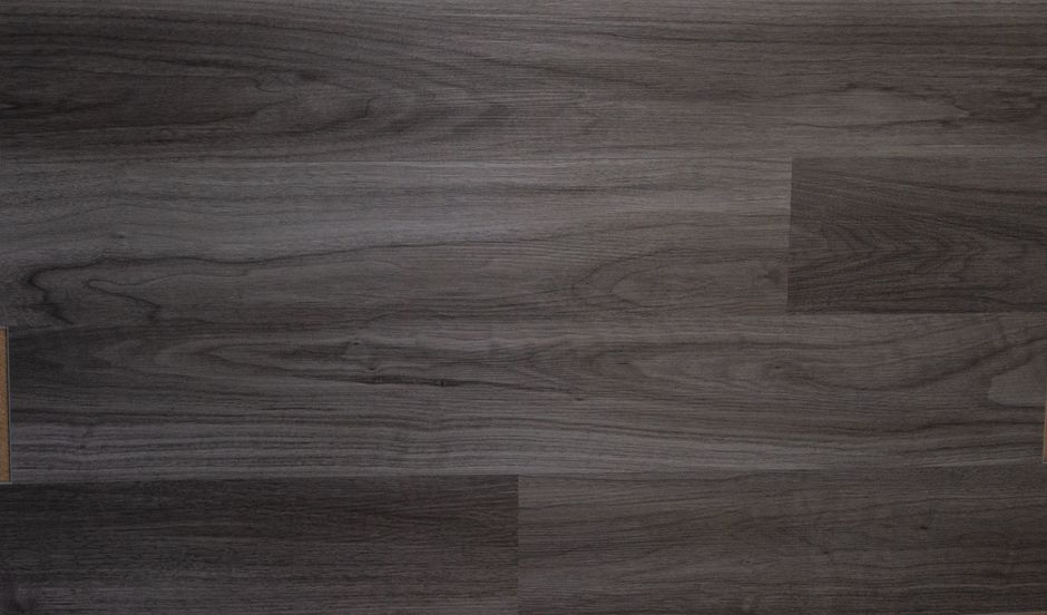 Porcelain tile and vinyl flooring meet in a busy home entryway with boots, mats, and everyday foot traffic.
